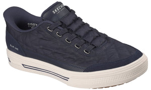A navy blue, quilted slip-on sneaker featuring a thick white rubber sole with dark blue accents, a padded collar, and the text "SKECHERS LOS ANGELES" on the tongue and "SLIP-INS" on the side.