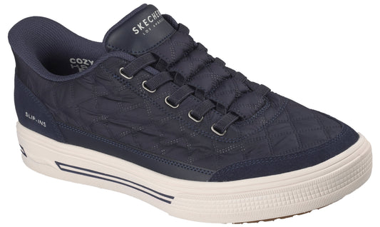 A navy blue, quilted slip-on sneaker featuring a thick white rubber sole with dark blue accents, a padded collar, and the text "SKECHERS LOS ANGELES" on the tongue and "SLIP-INS" on the side.