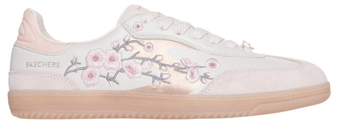 A light pink and white tennis shoe with floral embroidery.