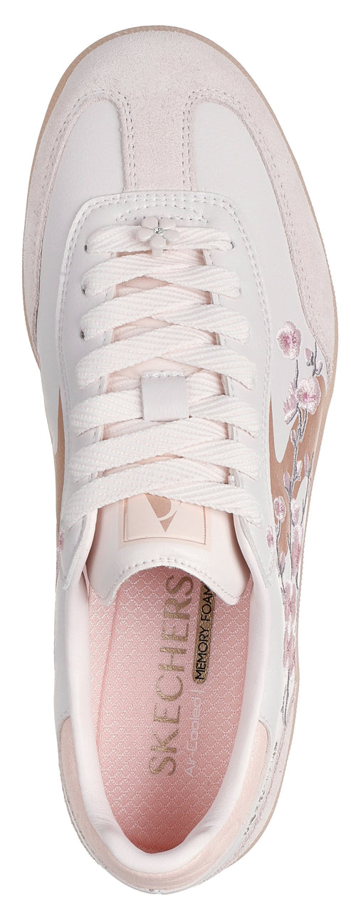 Top-down view of a pink and white sneaker with floral design.