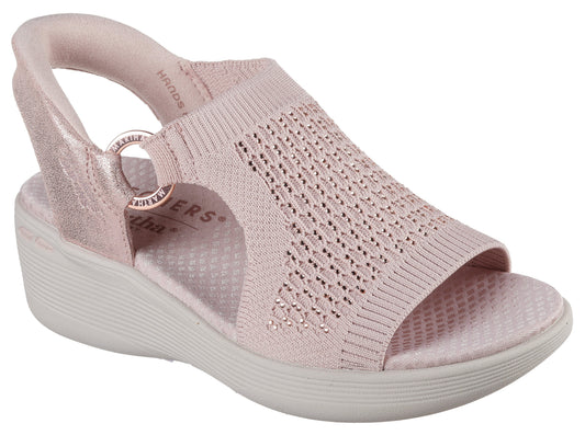 A pink wedge sandal with knit-textured upper, a peep-toe, and a looped back strap.