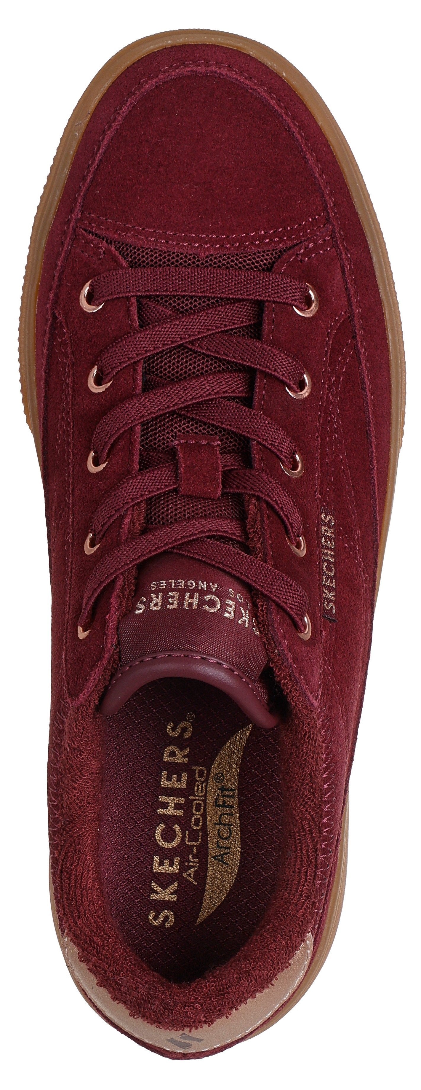 A top-down view of a burgundy suede sneaker featuring a lace-up front, a brown rubber sole, and a visible interior brand label reading Skechers Air-Cooled Arch Fit.