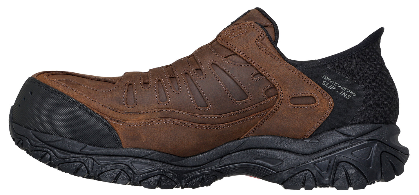 A brown slip-on shoe with black toe bumper and heel.