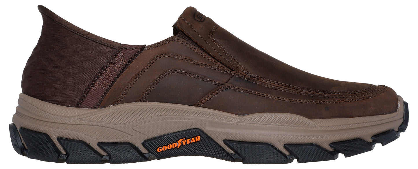 A brown slip-on casual shoe with a tan foam midsole, a rugged black outsole with Goodyear branding, and a textured dark brown rear panel.