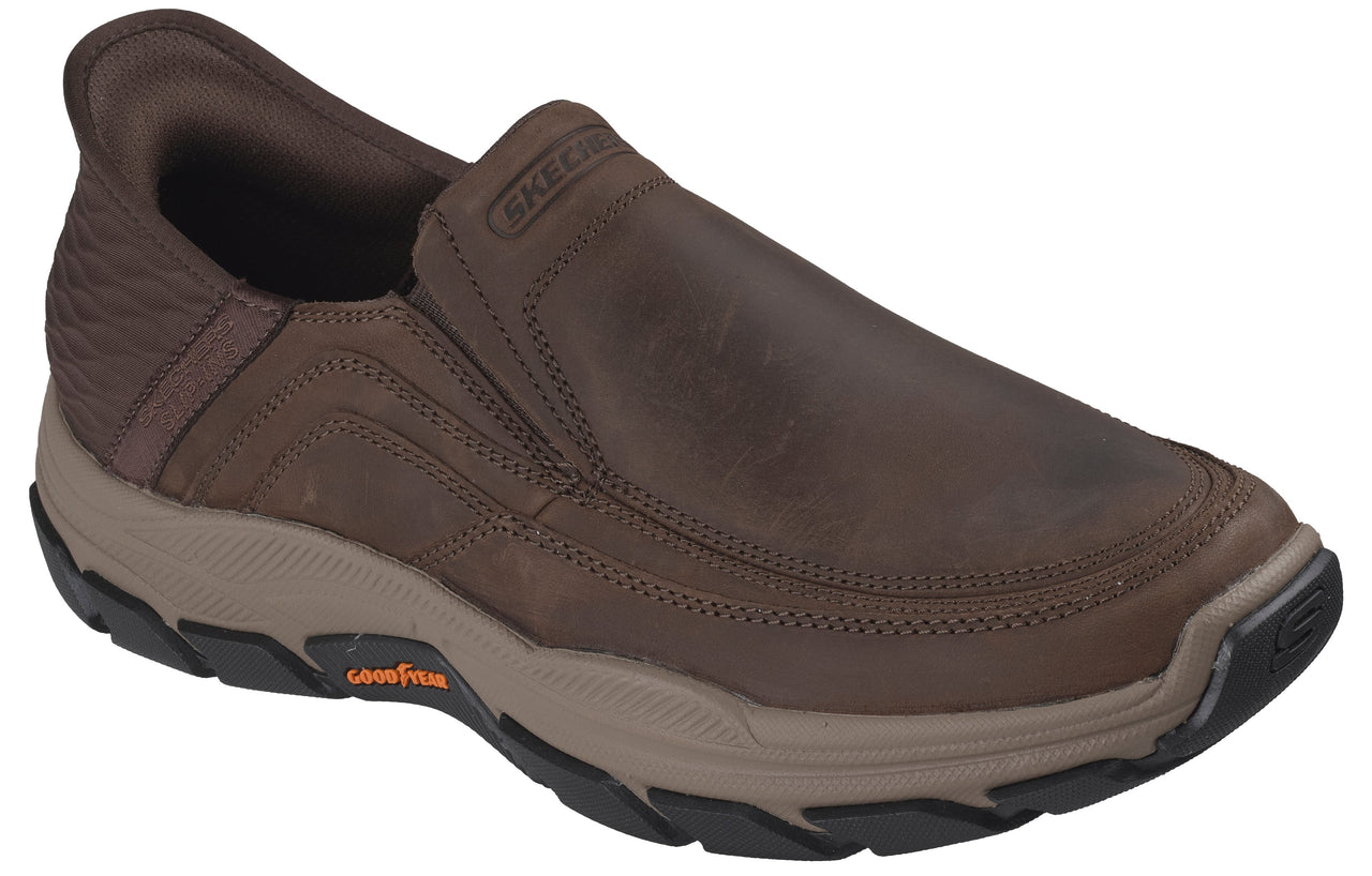 A brown slip-on casual shoe with visible SKECHERS branding on the collar and a tan midsole featuring Goodyear branding, set against a white background.