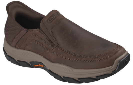 A brown slip-on casual shoe with visible SKECHERS branding on the collar and a tan midsole featuring Goodyear branding, set against a white background.