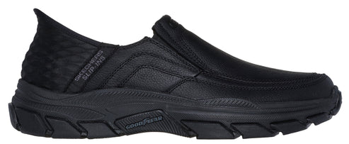 Black slip-on shoe with "SKECHERS SLIP-INS" label and Goodyear logo on the sole.