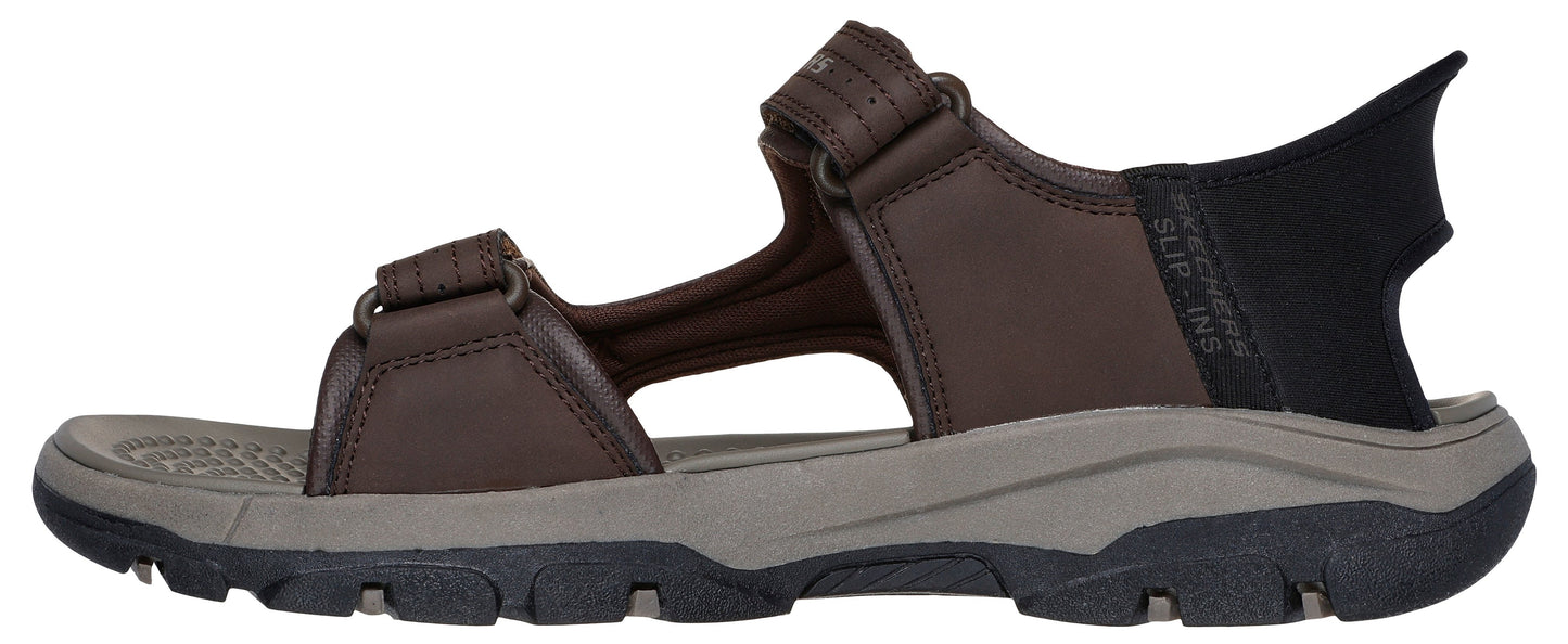 A brown sandal with black accents and two adjustable straps.