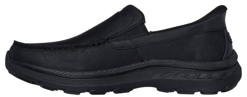 A black loafer-style shoe with a thick sole.