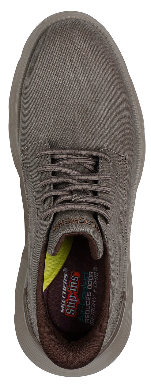 A close-up overhead view of a casual lace-up shoe, showcasing the shoe's laces and insole with visible text 'Skechers Slip-ins'.
