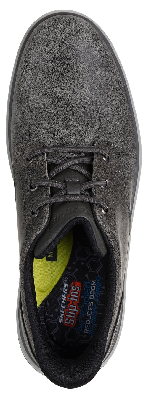 A top-down view of a dark grey Skechers Slip-ins shoe with lace-up styling, a black interior collar, and a yellow cushioned insole showing the text 'Skechers Slip-ins' and 'Reduces odor'.