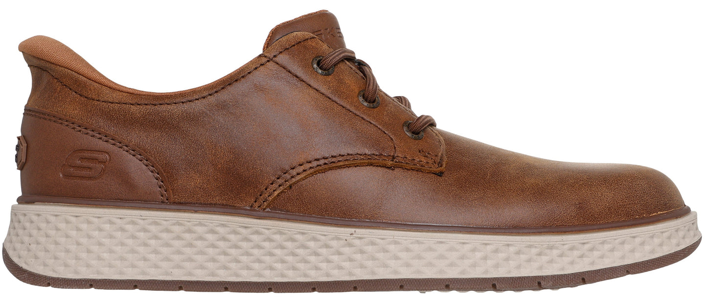 A brown leather casual shoe with a tan textured midsole and a visible S logo embossed on the heel