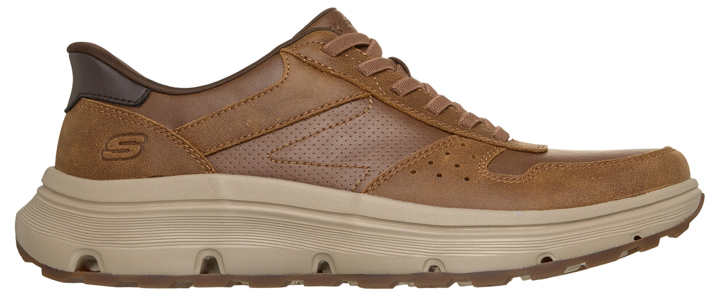 A brown leather Skechers sneaker with a thick, beige cushioned sole, a perforated mid-panel, and a dark brown heel accent, viewed from the side.