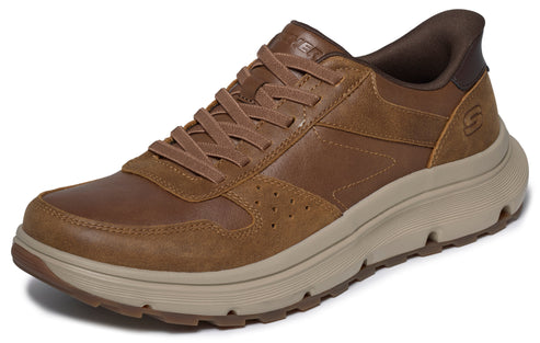 A brown leather low-top sneaker featuring matching laces, a beige cushioned midsole, a dark brown heel collar, and a textured rubber outsole.