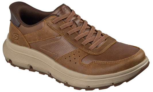 A brown leather low-top sneaker featuring a lace-up closure, a thick beige midsole with a textured grip, and a small S logo on the side.