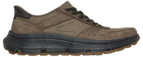 A brown leather low-top sneaker with a thick black rubber midsole and a brown treaded outsole, featuring a small embossed S logo on the side heel and dark laces.