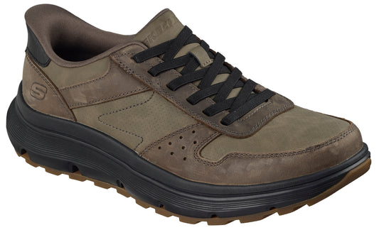 A low-top, olive-colored casual shoe with black laces and a dark, thick, textured midsole.