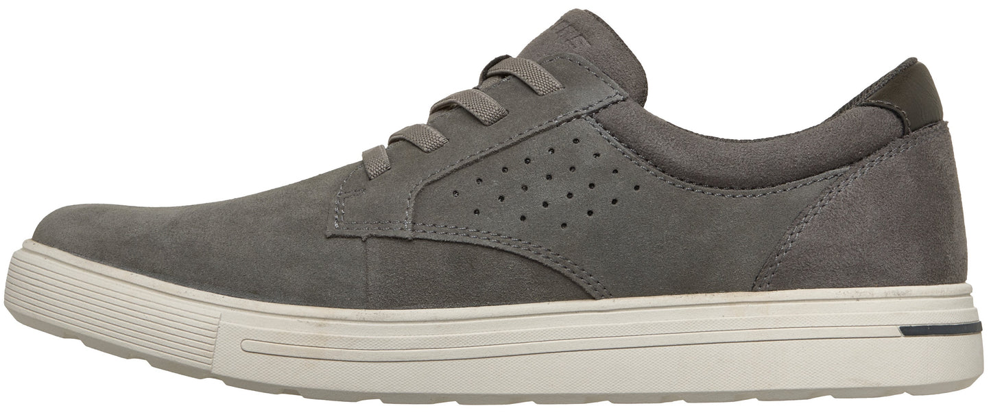 A gray low-top casual sneaker with a suede-like texture, featuring a lace-up front, perforated side panel detailing, and a thick white rubber sole with a subtle black accent at the heel.