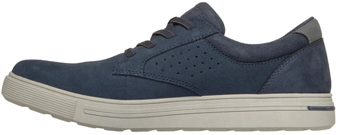 A side view of a low-top men's navy blue suede sneaker with a light grey rubber midsole and matching laces, featuring perforated detailing on the mid-panel.