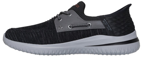 A gray and black slip on shoe with a light gray sole.