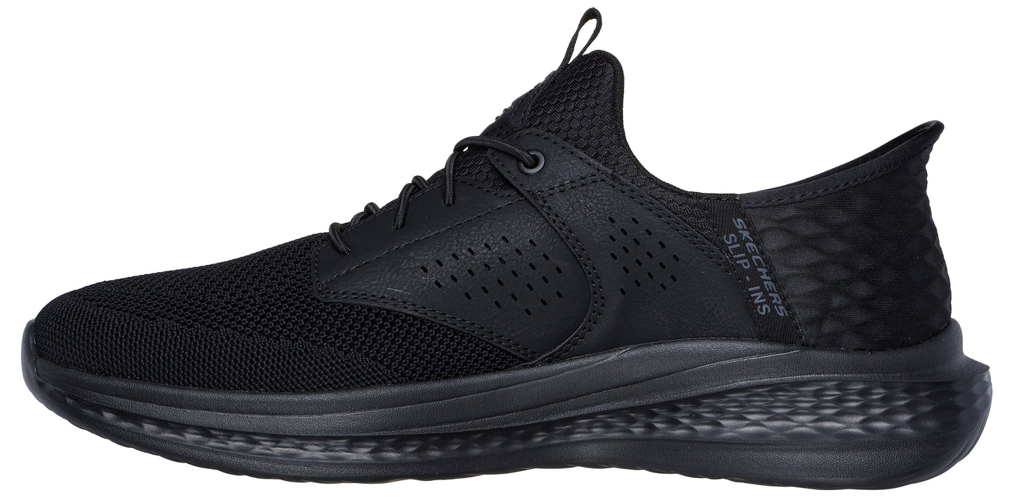 A black low-top athletic shoe with mesh fabric.