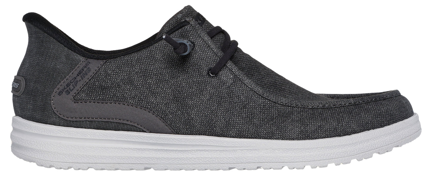 A gray canvas shoe with white sole and black laces.