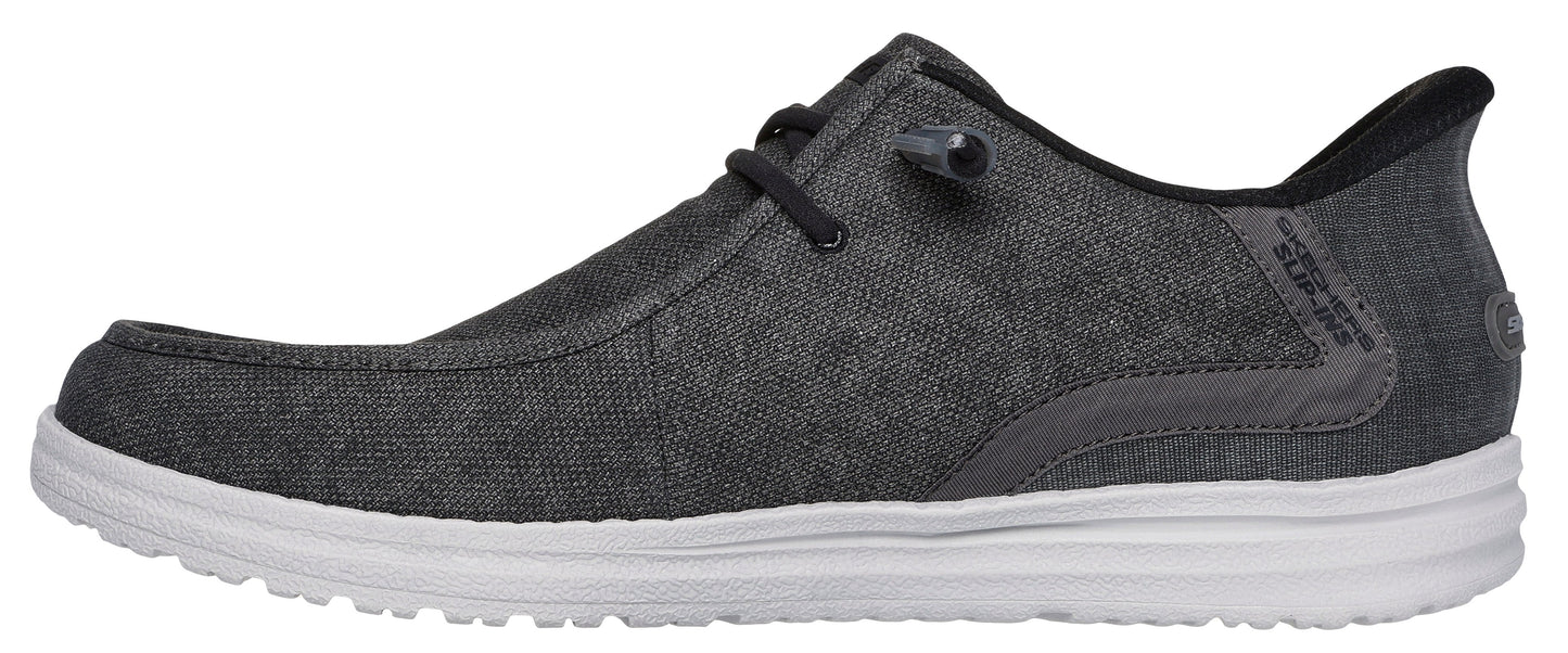 A grey shoe with a white sole and black laces.