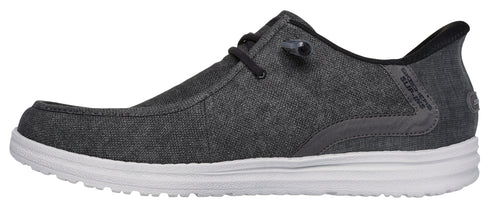 A grey shoe with a white sole and black laces.