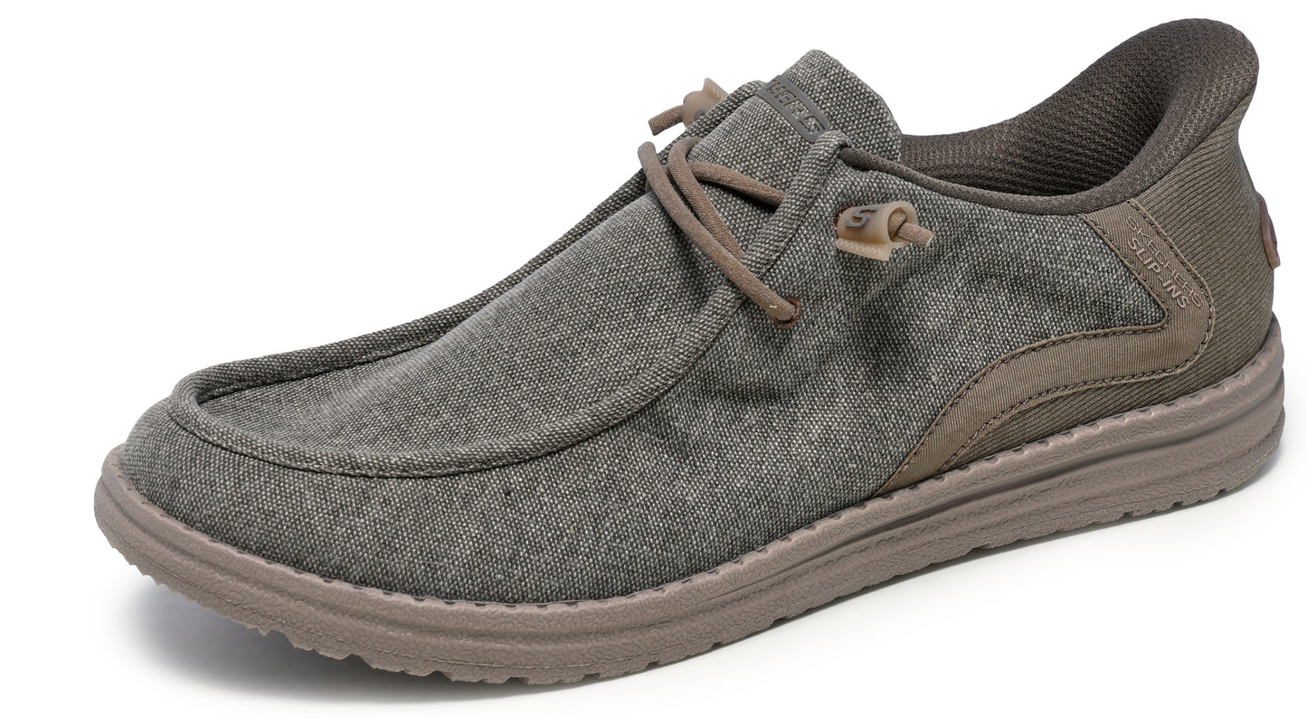Low profile dark gray canvas shoe with laces and brown sole.