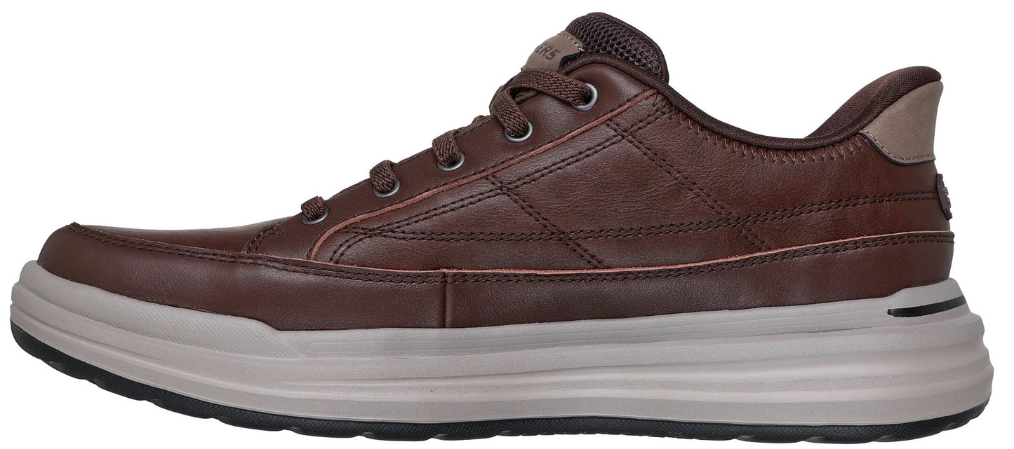 A brown leather sneaker with a light gray sole.