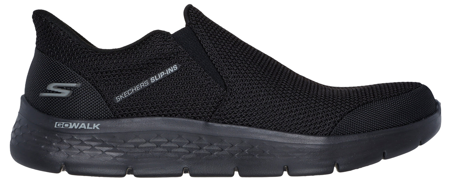 A black slip-on shoe with visible text 'SKECHERS SLIP-INS' and 'GO-WALK'.