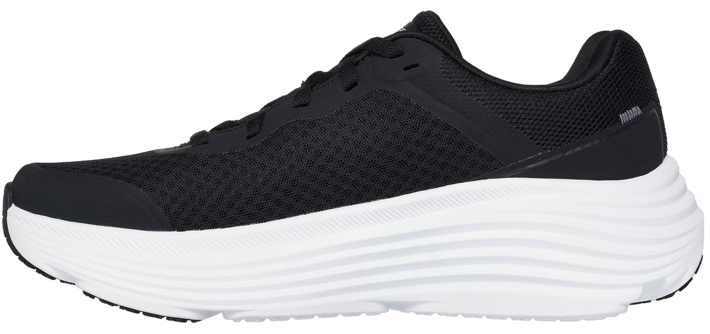 A black sneaker with a thick white sole.