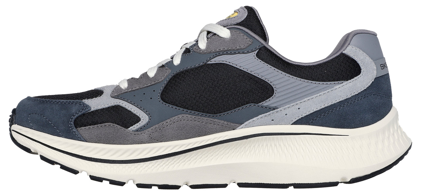 A side-view of a running shoe with blue, gray, and black panels, white laces, and a thick white sole.