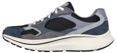 A side-view of a running shoe with blue, gray, and black panels, white laces, and a thick white sole.