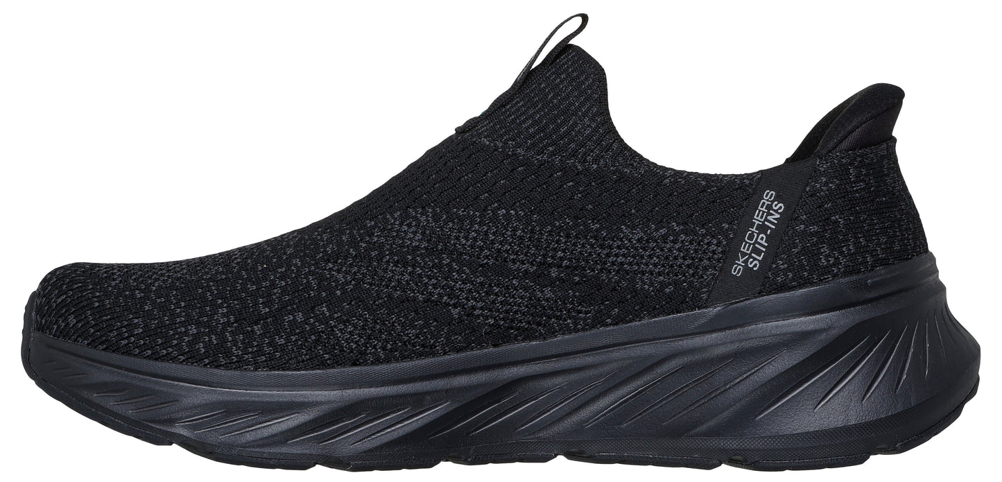 A black slip-on sneaker with a knit upper and thick sole.