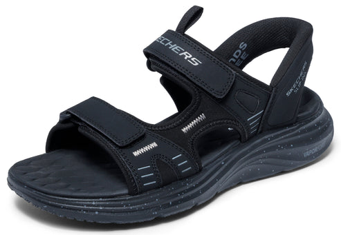 Black sandal with velcro straps and white stitching.
