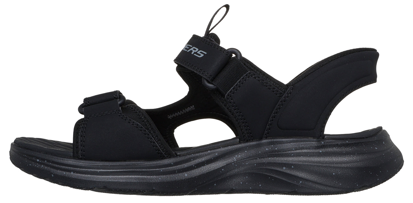 A black sandal with hook and loop straps.