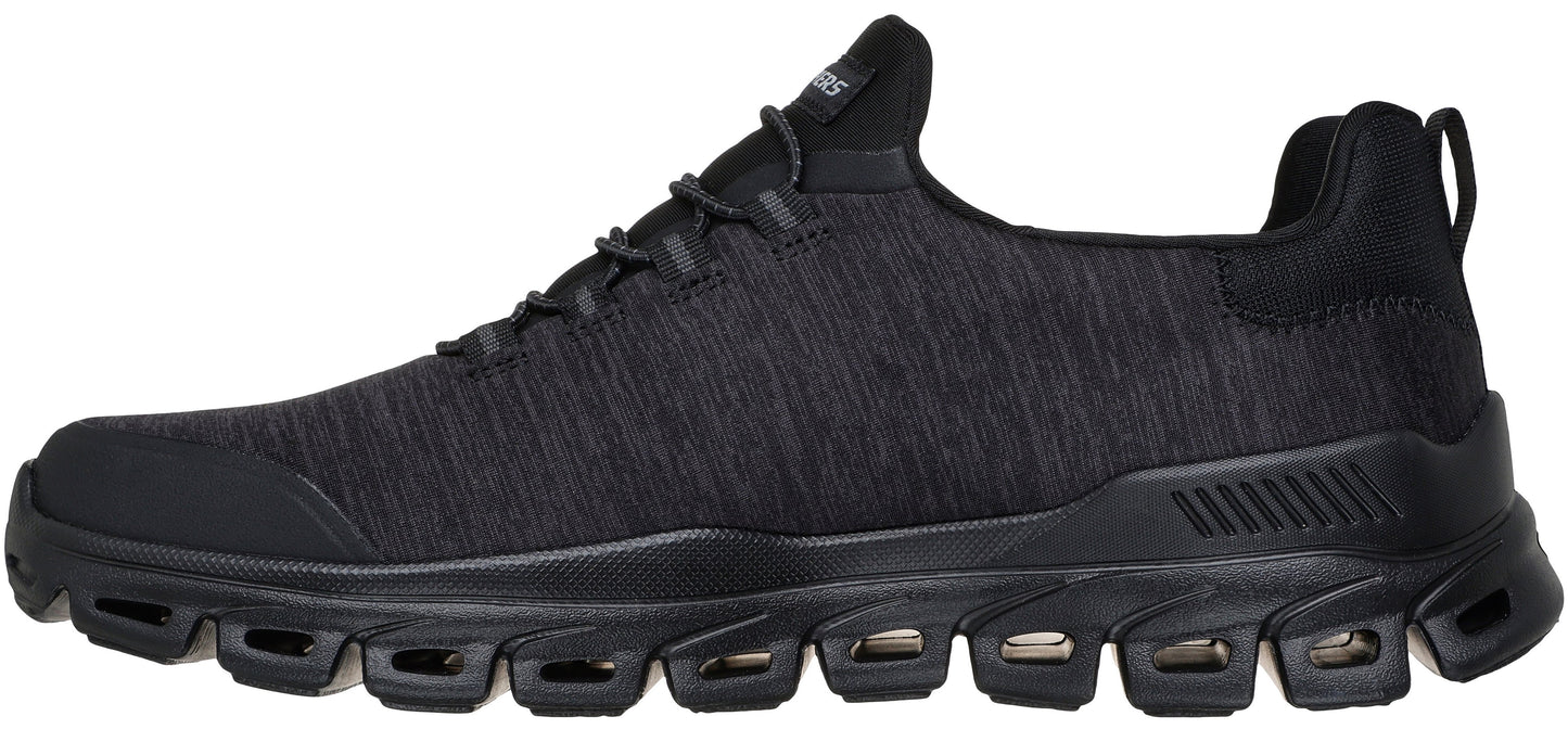 A black men's athletic sneaker with a textured knit upper, laces, and a thick, segmented, black sole with cutouts.