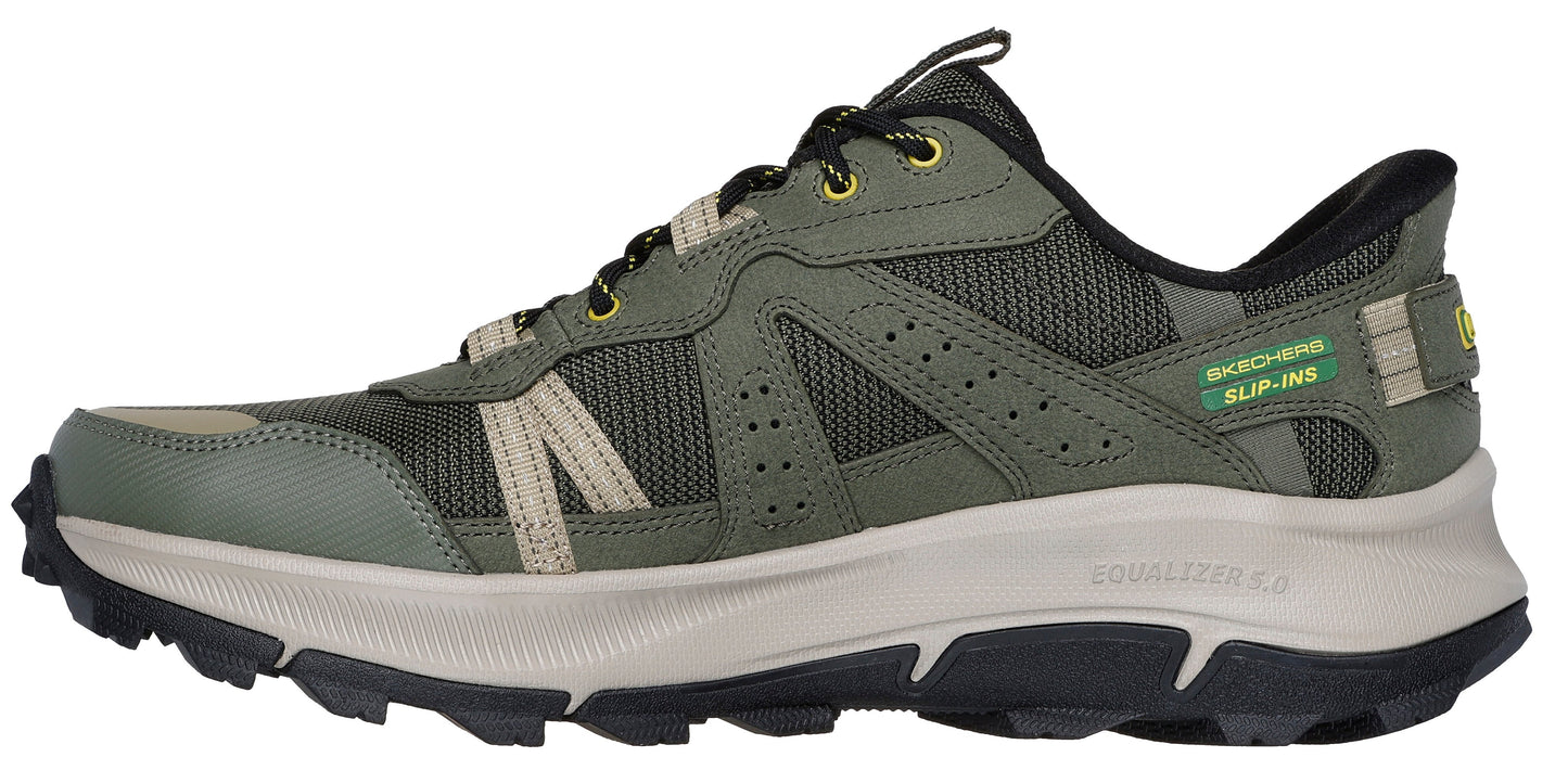 A green athletic shoe with a black sole and laces.