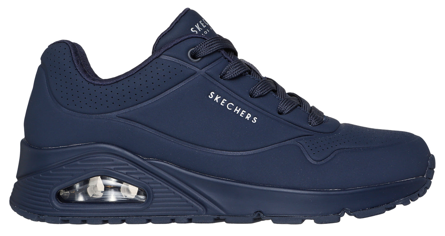 Navy sneaker with laces, perforated side panels, and visible air cushioning.