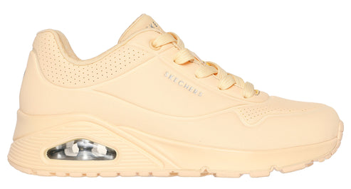 Beige sneaker with air cushioned sole, lace-up closure, and a perforated collar.
