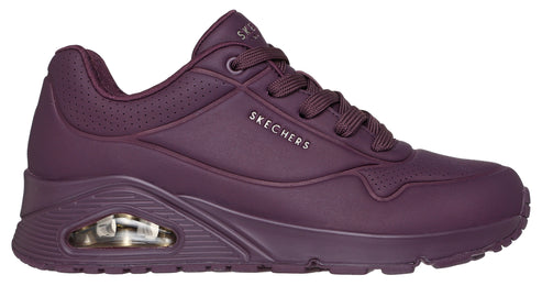 Side view of a maroon sneaker featuring a cushioned sole and the word "SKECHERS".