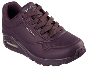 A plum-colored sneaker with laces, a visible air pocket in the heel, and the text "SKECHERS LOS ANGELES" and "SKECHERS" visible on the upper.