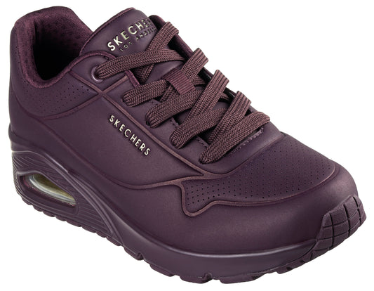 A plum-colored sneaker with laces, a visible air pocket in the heel, and the text "SKECHERS LOS ANGELES" and "SKECHERS" visible on the upper.