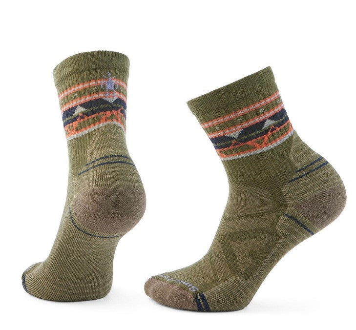 Pair of olive-green socks with brown heels and toes, and patterned cuffs with black, orange, and pink geometric shapes.