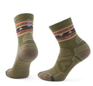 Pair of olive-green socks with brown heels and toes, and patterned cuffs with black, orange, and pink geometric shapes.