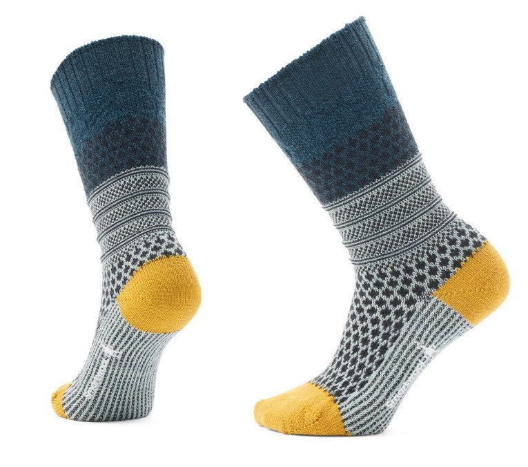 A pair of patterned wool socks in navy, gray and yellow, shown at an angle.