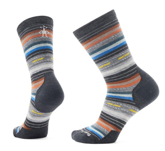 A pair of patterned wool crew socks: dark grey heel and toe; horizontal stripes of grey, orange, white and blue; small stick figure logo.