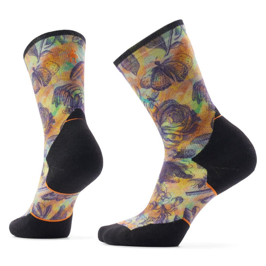 Two patterned hiking socks with insect and floral design, and black heel and toe.