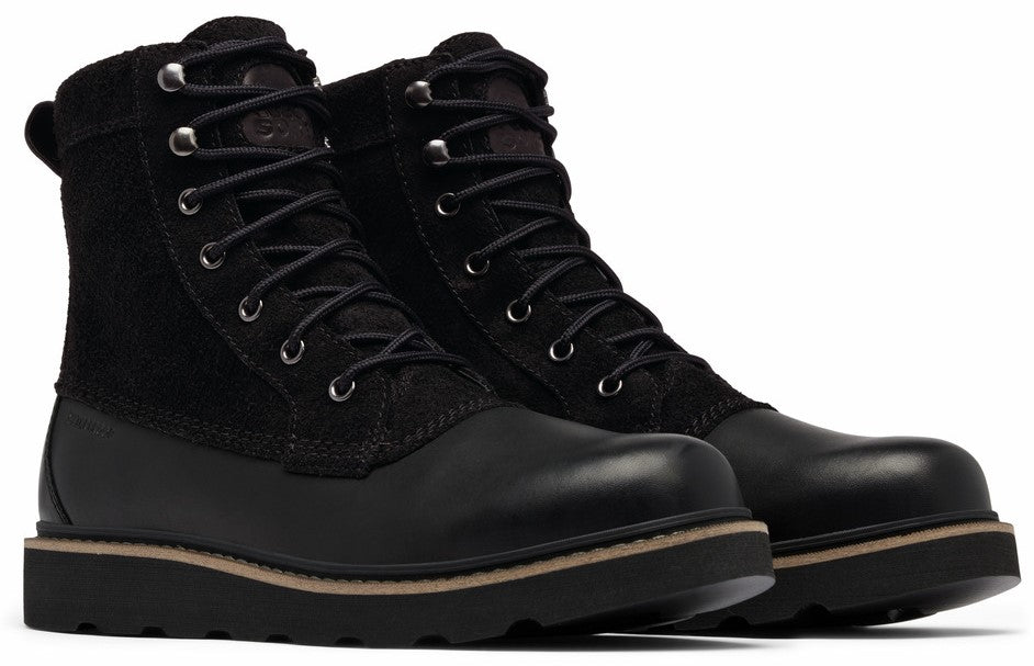 A pair of ankle-high black leather boots with corduroy trim and laces.